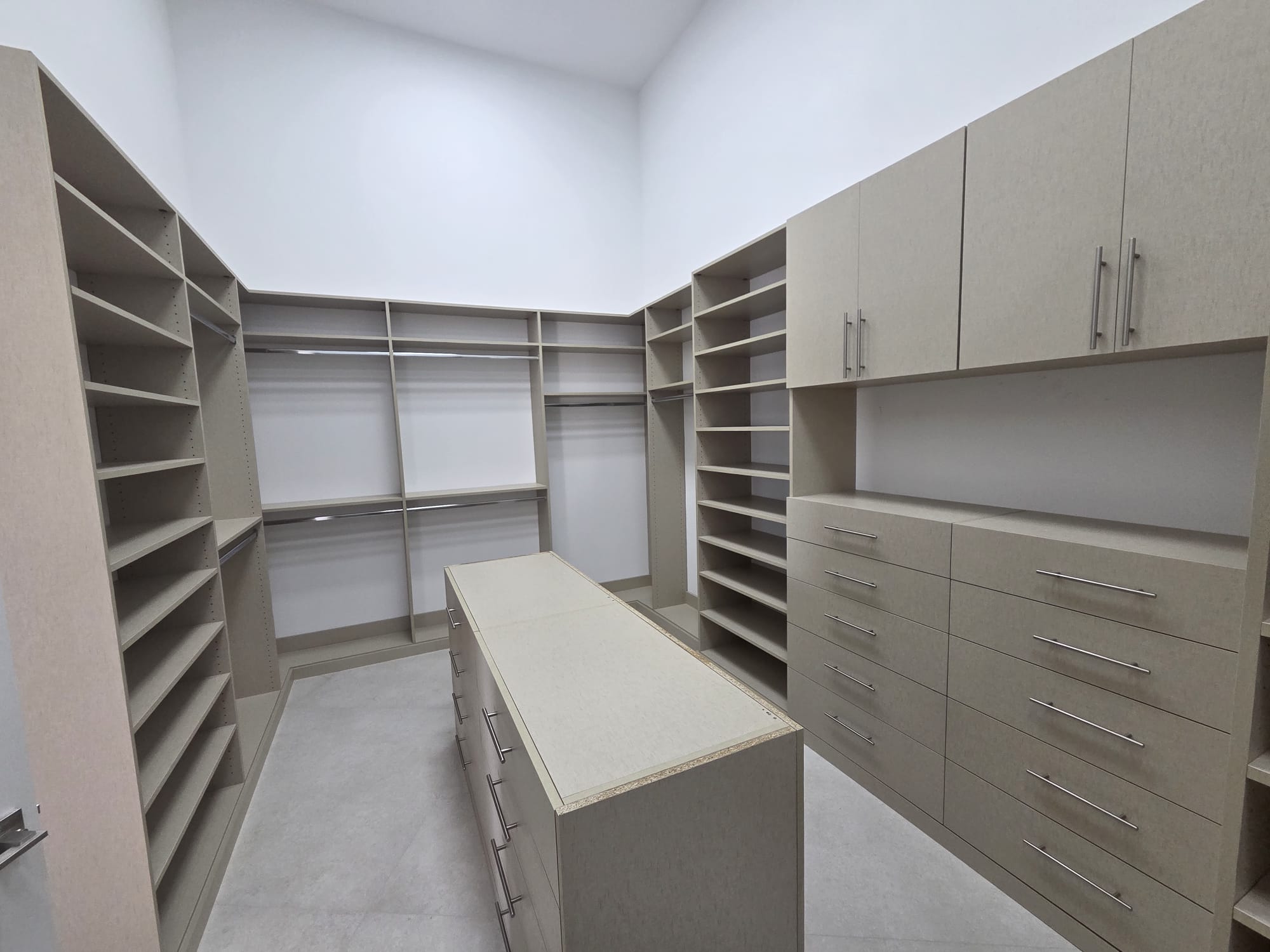 Custom walk-in closet with center island, designed and installed by COPLASA
